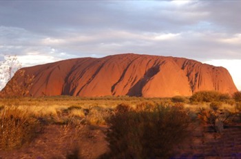 uluru sun breaking through the clouds 